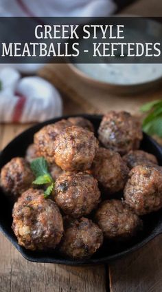 meatballs in a black bowl on a wooden table