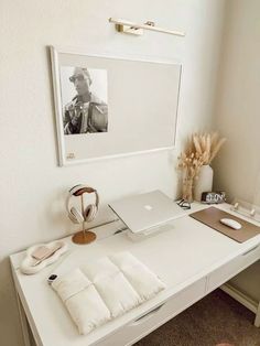 a white desk topped with a laptop computer