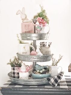 a three tiered tray with coffee cups and other items