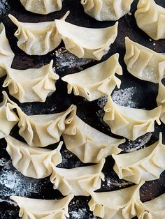 some dumplings are sitting on a baking sheet