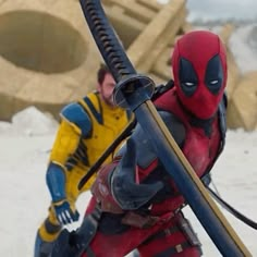 deadpool and wolverine in action on the snow covered ground with two people behind them