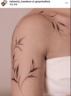 the back of a woman's arm with tattoos on it