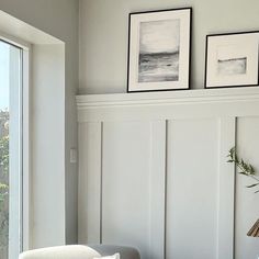 a living room with two framed pictures on the wall