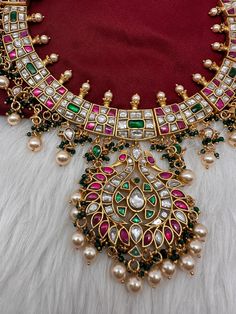 Jadau Kundan Multi Color Neckline Necklace with Emerald Beads with matching JhumkasColor : GoldenSize : Necklae Length : 14 Inches; No EarringsStones : Jadau Kundan Red Green Clear Jadau Kundan Emerald Beads Luxury Multicolor Kundan Necklace With Gemstones, Multi Color Kundan Necklace, Luxury American Diamond Kundan Necklace For Diwali, Luxury Emerald Kundan Necklace With Gemstones, Luxury Emerald Necklace For Diwali Festive, Luxury Kundan Emerald Gemstone Necklace, Luxury Multicolor Gemstone Kundan Necklace, Luxury Emerald Kundan Necklace In Temple Jewelry Style, Luxury Gold Kundan Necklace With Gemstone Beads