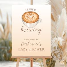 a welcome sign for a baby shower with a cup of coffee on it and the words,'a baby is brewing welcome to catherie's baby shower '