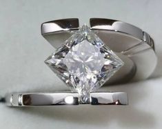 a ring with a princess cut diamond on it