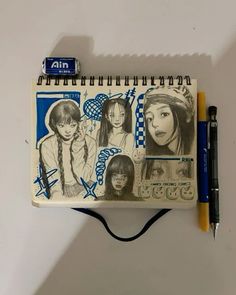 a notebook with some drawings on it next to a pen