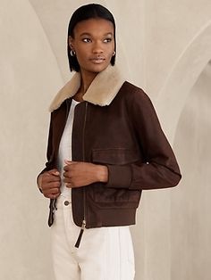 Up, up and away—this vintage-inspired pilot bomber is everything you could ask for.  With a removable shearling collar, the design offers more ways to style.  Crafted from exceptionally soft lambskin in a slightly oversized silhouette, this modern Fall Leather Jacket With Contrast Collar, Chic Shearling Leather Jacket For Work, Classic Aviator-style Outerwear For Fall, Classic Aviator Outerwear For Fall, Chic Fall Outerwear With Ribbed Collar, Aviator Leather Jacket With Padded Collar For Fall, Fall Aviator Leather Jacket With Padded Collar, Fitted Aviator Outerwear For Fall, Womens Moto Jacket