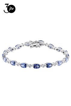 Bella Luce �� Esotica��� tanzanite and white diamond simulants 13.21ctw oval and round, rhodium over sterling silver tennis bracelet. Measures approximately 7" or 7.5"L x 0.13"W and has a hidden box closure. Silver Tennis Bracelet, Diamond Simulant, Tennis Bracelet, White Diamond, Cubic Zirconia, Tennis, Blue And White, Bracelet, Sterling Silver