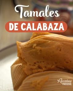 a close up of food on a plate with the words tamales de calabza