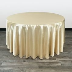 Due to their glimmering beauty, 120 inch round satin tablecloths have become the most popular tablecloth in the wedding and event industry. They are designed to fully drape the most common table used in banquet halls and wedding reception centers, the 60 inch round table with 30 inch height. In simple terms, a 120-inch round tablecloth will drop all the way to the floor, giving the table an elegant appearance. Aside from that fact that they are fully drapable, wedding planners and fine-dining pr Table Overlays, Party Table Cloth, Photography Decor, Tablecloth Sizes, Table Skirt, Mantel Redondo, Satin Color, Get Yours Now, Catering Services