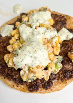 a flatbread topped with corn and cream sauce