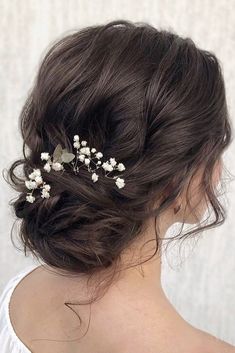 a woman wearing a hair comb with flowers in it