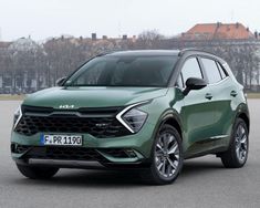 a green suv parked in front of a building