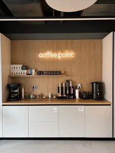 a coffee shop with the word coffee point lit up on the wall above the counter