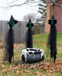 three black witches are standing in the grass