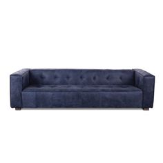 a blue couch sitting on top of a white floor