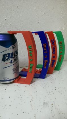 a can of beer sitting on top of a counter next to four coasters that say bus life