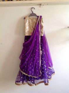 Beautiful deep purple lehenga with sparkling gold crop top  The outfit comes with a matching dupatta with stones all over. Available in custom colors Made to your little one's measurements.  I will send a measurements sheet once you order or you can message me the age( Standard size) Please don't hesitate to convo me if you have any questions. Purple Sequin Sharara For Diwali, Traditional Purple Sequined Sets, Purple Traditional Drape Sets For Celebration, Purple Party Wear Sets For Festive Occasions, Bollywood Style Purple Celebration Sets, Purple Bollywood Sets For Celebration, Purple Celebration Sets For Navratri, Purple Sequined Traditional Wear For Diwali, Bollywood Style Purple Sequined Dupatta