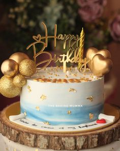 a birthday cake with gold decorations on top