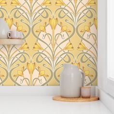 a yellow wallpaper with white vases and cups on the shelf next to it