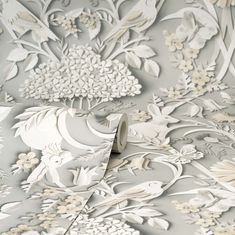 an artistic wallpaper design with flowers and birds in white, grey and silver colors