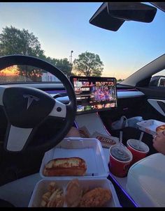 a person sitting in a car with some food