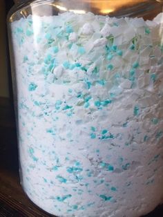 a cake in a jar with blue and white sprinkles