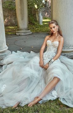 a woman sitting on the ground in a dress