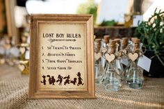 a wooden frame sitting on top of a table filled with bottles