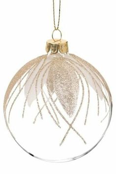 a glass ornament hanging from a gold chain