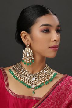 22K Gold plated collar style necklace with kundan embellished motifs, pearl and emerald bead drops. Paired with a pair of kundan earrings.
Components: 1 Necklace, Pair of Earrings
Type: Kundan
Composition: Mixed metal alloy
Color: Gold
Pearl drops
Kundan studded
Closure: Adjustable string - Aza Fashions Jewellery Set Gold, Kundan Necklace Set, Kundan Necklace, Emerald Bead, Kundan Earrings, Kundan Necklaces, Mens Accessories Jewelry, Jewellery Set, Buy Gold