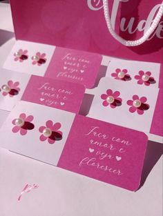 some pink and white cards with flowers on them