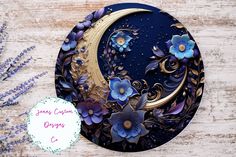 a paper plate with blue flowers and a crescent moon on the side, next to a purple flower bouquet