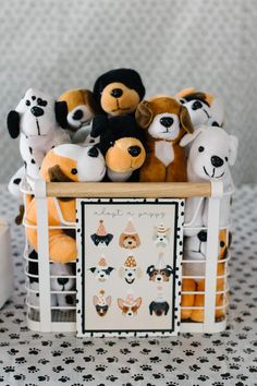 a basket filled with lots of stuffed animals on top of a white and black table