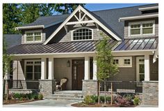 a gray house with white trim and windows