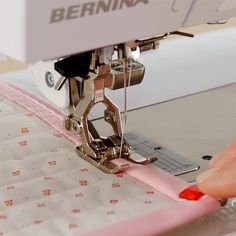 someone is using a sewing machine to sew something on a piece of fabric that has been stitched together