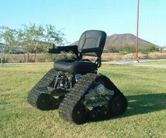 a black lawn tractor sitting in the grass