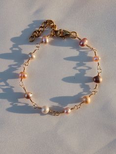 This adorable pearl bracelet is super dainty and lightweight, but very long lasting. It's made using multicolored violet/pink freshwater pearls. These pictures do not do it justice! This bracelet feels so classy and elegant and only for a price of 15.99. This bracelet comes with a one inch extension chain, so it can be adjusted; at no extra cost:)  Sizes range from 4 inches to 8 inches.(plus an extra inch with the extension chain) Feel free to message me if needing a different size, I will be mo Pink Dainty Pearl Bracelet, Dainty Pink Pearl Bracelet With Pearl Charm, Everyday Pink Pearl Jewelry, Pink Flower Ring, Daisy Bracelet, One Inch, Pearl Chain, Pink Pearl, Beaded Rings