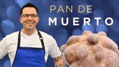 a man standing next to a loaf of bread with the words pan de muerto on it