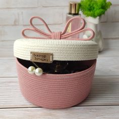 a pink and white basket filled with personal items