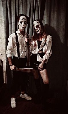 two people dressed up as zombies holding knives