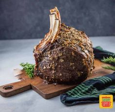 a large piece of meat sitting on top of a wooden cutting board