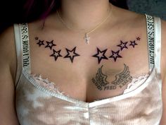 a woman with tattoos on her chest and stars