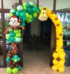 a balloon arch decorated with animals and balloons