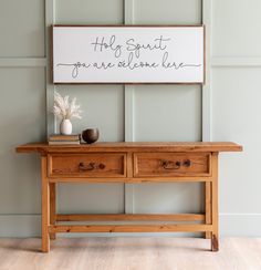 a wooden table with two drawers and a sign above it that says laundry co wash dry fold