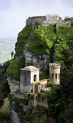 an old castle perched on top of a cliff