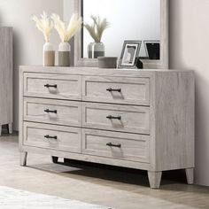 a white dresser and mirror in a room