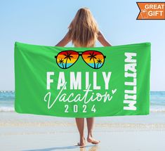 a woman holding a green beach towel with sunglasses on it that says family vacation 2012