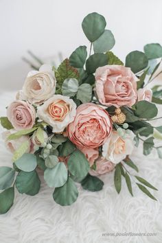 a bouquet of flowers sitting on top of a white blanket